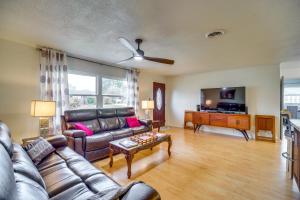 a living room with a couch and a table at Centrally Located Merritt Island Home Pool, Porch in Merritt Island