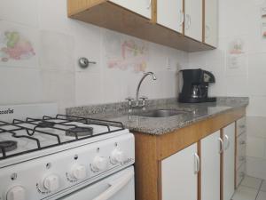 a kitchen with a stove and a sink at La Victoria in Rosario