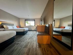 a hotel room with two beds and a window at Modesto Hotel - Suite A in Modesto