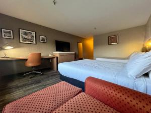 a hotel room with two beds and a desk at Modesto Hotel - Suite A in Modesto
