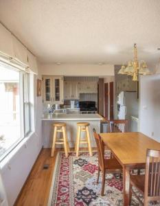 a kitchen with a table and stools in a room at Private 313 Acre retreat/lakes/direct forest entry in Buena Vista