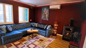 a living room with a blue couch and a stove at Central single house with parking-TOP LOCATION! in Novalja