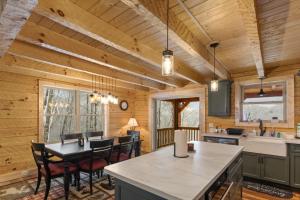 a kitchen and dining room in a log cabin at Cozy Rustic Cabin in Sugar Mountain +19 photos