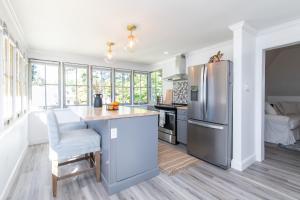 a kitchen with a stainless steel refrigerator and a counter at Loft on Capital - Ideally located to Distilleries in Frankfort