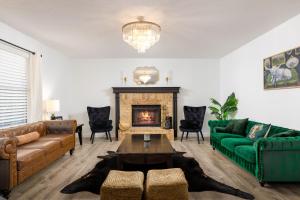 a living room with a couch and a fireplace at Timeless-Texas-Inn - Heated Pool Oasis & Lux Vibe in Round Rock