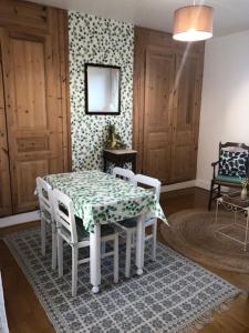 a dining room table and chairs with a table and a table and chairs at Les Hortensias in Amiens