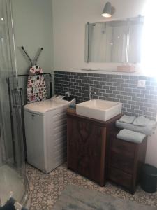 a bathroom with a sink and a toilet and a mirror at Les Hortensias in Amiens