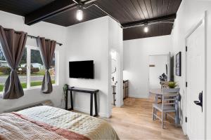 a bedroom with a bed and a desk and a television at South Bay Inn in Westport