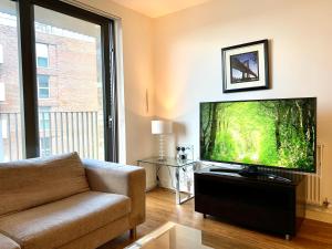 a living room with a large flat screen tv at Modern London Excel 2 Bedrooms 2 Bathrooms, Parking, Kitchen, Lounge, Balcony Apartment in London
