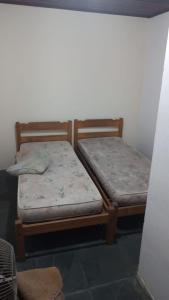 Tempat tidur dalam kamar di Pousada do Toninho