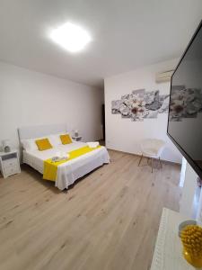 a bedroom with a bed with yellow sheets and yellow pillows at CASA ROSELLINA SORRENTO in Sorrento