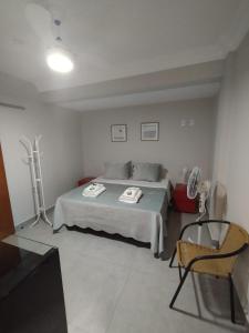 a bedroom with a bed and a chair in it at Job&Joy Business Hostels in Campinas