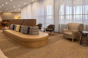 a lobby with a couch and chairs and a table at Holiday Inn El Paso West – Sunland Park, an IHG Hotel in El Paso