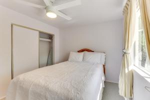 a white bedroom with a bed and a window at Convenient Mesa Apartment about 9 Mi to Downtown in Leisure World