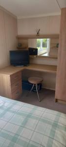a room with a desk and a chair and a window at The Chill Out at Seton Sands in Port Seton