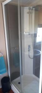 a shower with a glass door in a bathroom at The Chill Out at Seton Sands in Port Seton