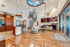 a living room with wood floors and a staircase at Beachfront,V Private, 360 Views, Sunsets, Hottub in Captiva