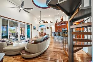 a living room with a couch and a table at Beachfront,V Private, 360 Views, Sunsets, Hottub in Captiva +86 photos