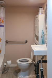 a bathroom with a toilet and a sink at Cozy stay close to Merivale in Ottawa