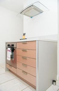 a kitchen with a sink and a stove at Inners City Apartments -On Suites in Birmingham