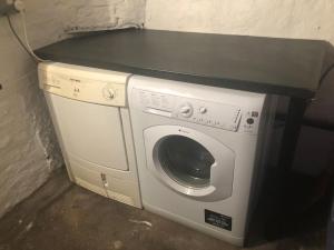 a washing machine with a black counter on top of it at Harbour Hideaway, Scarborough. Old Town in Scarborough