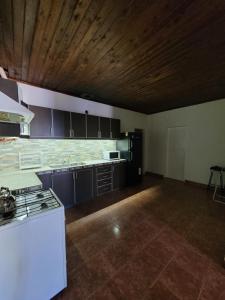 an empty kitchen with a stove and a counter top at Departamento Castello in El Bolsón