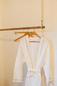 a white robe hanging on a hanger at Oxygen Paje Hotel in Paje