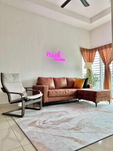 a living room with a brown couch and a chair at Nawwarah Homes @ Southville City (WiFi + NETFLIX) in Kajang