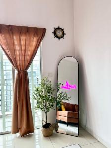 a mirror in a room with a couch and a curtain at Nawwarah Homes @ Southville City (WiFi + NETFLIX) in Kajang
