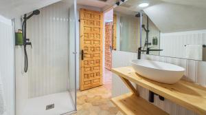 a bathroom with a large white sink and a shower at Hotel BESTPRICE Santillana in Santillana del Mar