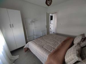 een persoon die op een bed in een slaapkamer ligt bij Coquette Appartement in Boumhel El Bassatine