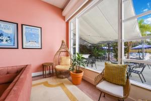 a living room with a couch and a large window at Tropics Hotel Miami Beach in Miami Beach