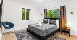 a bedroom with a bed and a blue chair at New Hidden Gem in Miami +34 photos