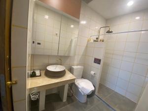 a bathroom with a sink and a toilet at Lemon Guesthouse in Chiang Mai