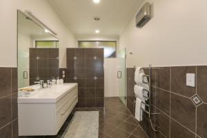 a bathroom with a sink and a shower with a mirror at Eagles Nest - Kinloch in Kinloch
