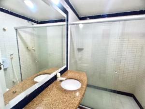 a bathroom with two sinks and a large mirror at Victory Flat in João Pessoa +30 photos