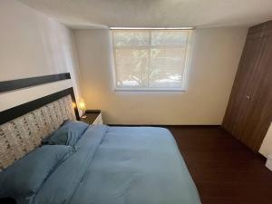 Ein Bett oder Betten in einem Zimmer der Unterkunft Oasis 101
