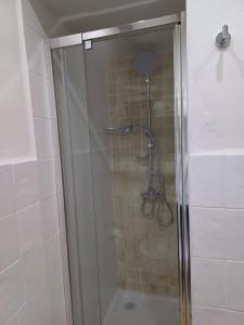a shower with a glass door in a bathroom at La casita Ronda in Ronda