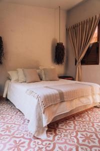 a bedroom with a large bed in a room at Las Dunas Beach Guest House in Juan de Acosta