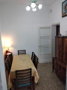 a dining room with a table with chairs and a dresser at La Dorada , Casa entera en Excelente Zona Residencial con cochera techada in Rosario