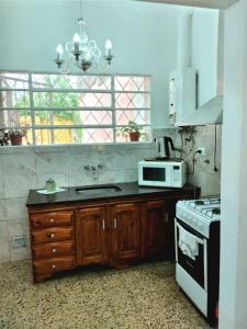 cocina con fregadero y microondas en La Dorada con cochera techada en Rosario