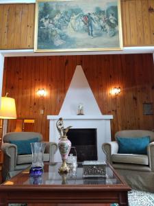 a living room with a table and a fireplace at La Dorada , Casa entera en Excelente Zona Residencial con cochera techada in Rosario