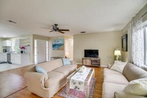 a living room with a couch and a table at Palm Bay Home with Screened Porch - 8 Mi to Beaches! in Palm Bay
