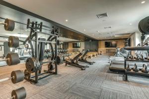 a gym with several rows of equipment in a room at Fort George Hotel and Spa in Belize City