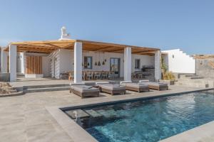 a villa with a swimming pool and a house at Villa Almi in Mykonos in Tourlos