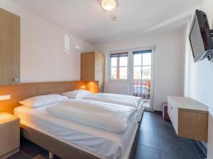 a bedroom with a large bed and a television at Mountainview in Kaprun +30 photos