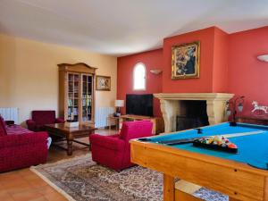 a living room with a pool table and a fireplace at Roco Aigle 
