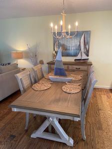 a dining room table with a model boat on it at 180 Ocean Hibiscus Drive in Butler Beach
