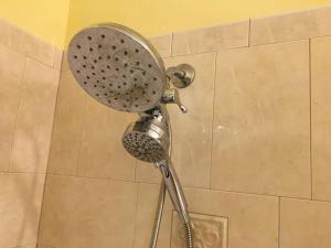 a shower with a shower head in a bathroom at Beach, Oceanfront, Flagler Beach Rental in Flagler Beach +21 photos