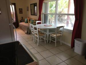 a kitchen with a table and chairs and a window at Beach, Oceanfront, Flagler Beach Rental in Flagler Beach